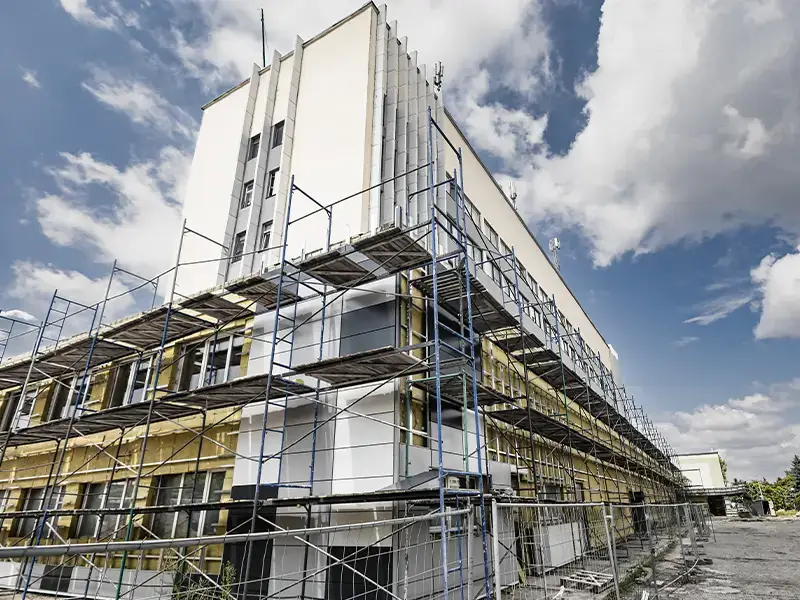 Building under renovation with scaffolding around it